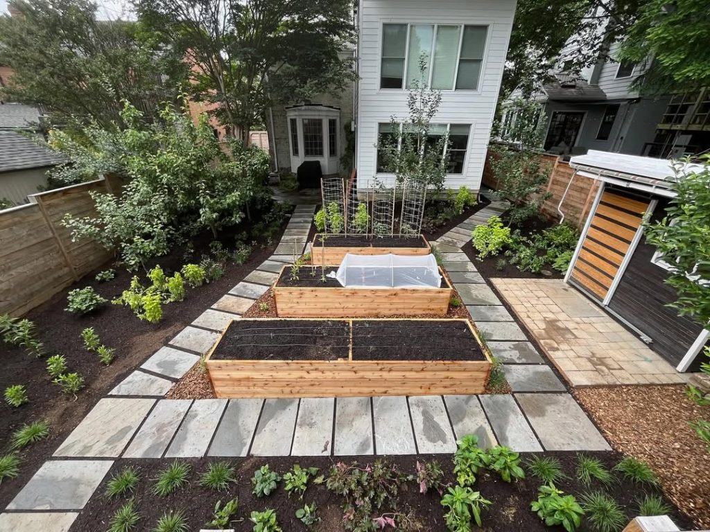 Cedar raised beds with stone pathway and cold frame