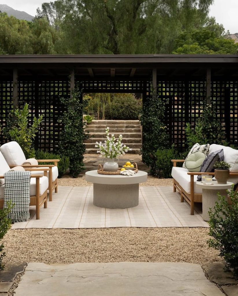 Modern patio with black lattice screens teak furniture and stone steps
