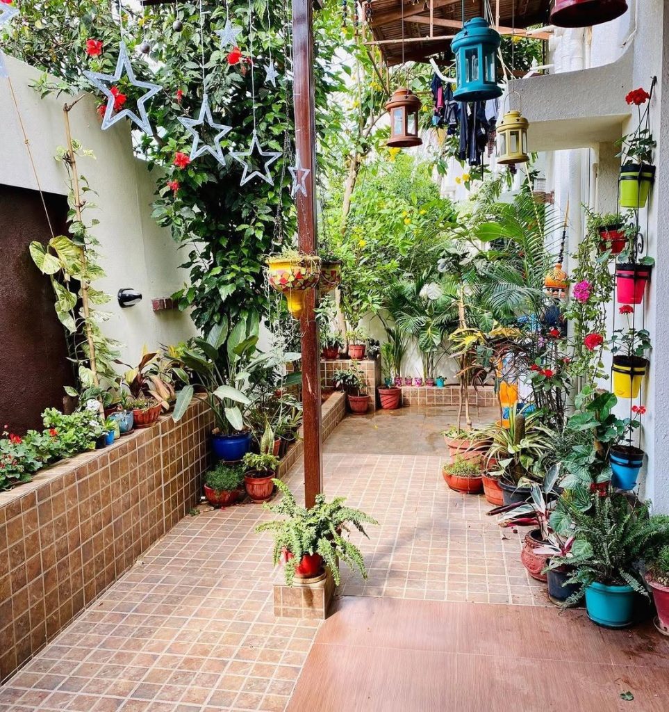 Indoor outdoor corridor with potted plants colorful lanterns and tile floor