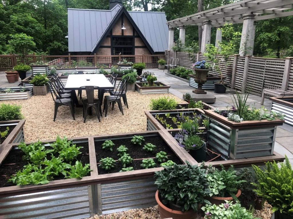 Metal raised garden beds surrounding outdoor dining area