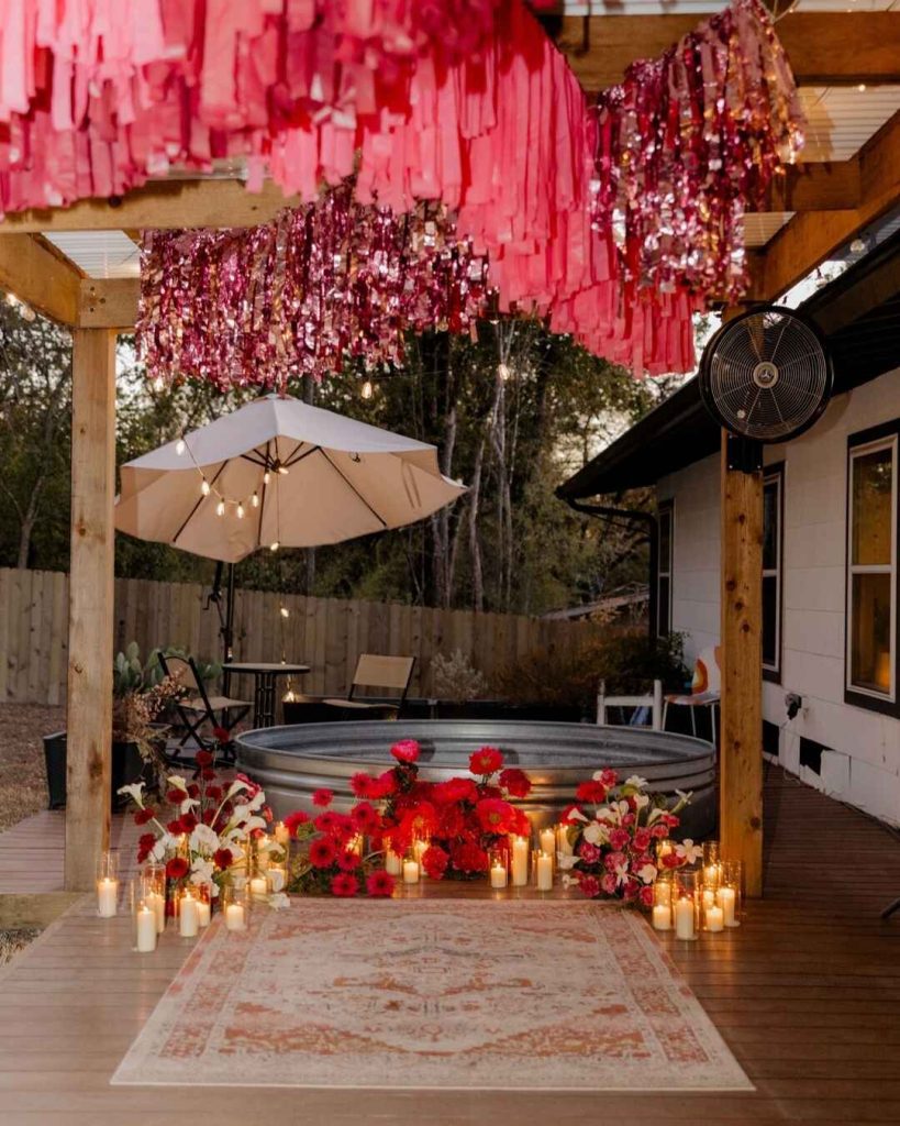 Backyard pool area with pink streamers red flowers and candlelight