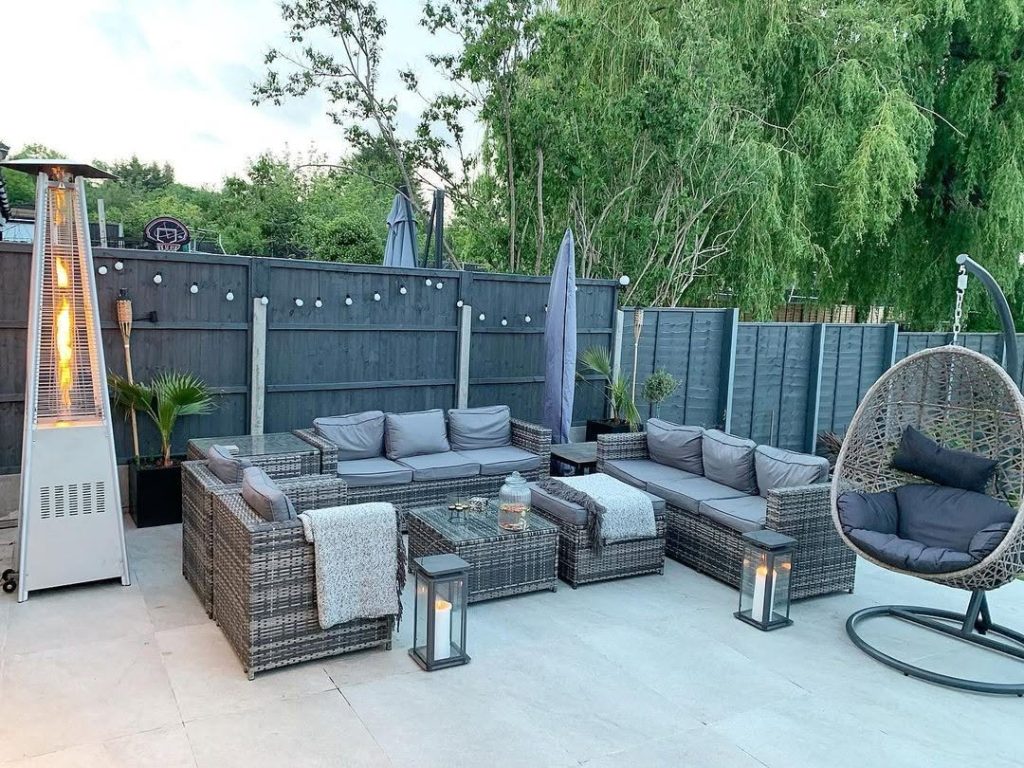 Modern patio with gray wicker furniture and hanging chair