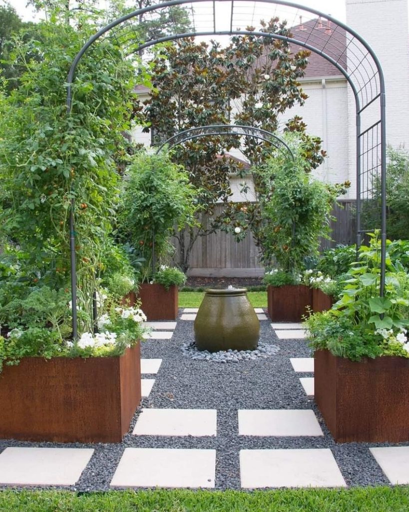 Modern garden path with metal planters and water feature