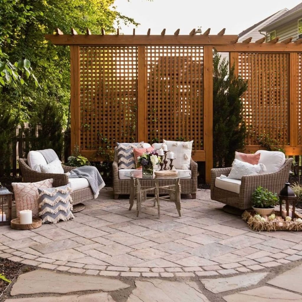 Patio with lattice screens wicker furniture and stone pavers