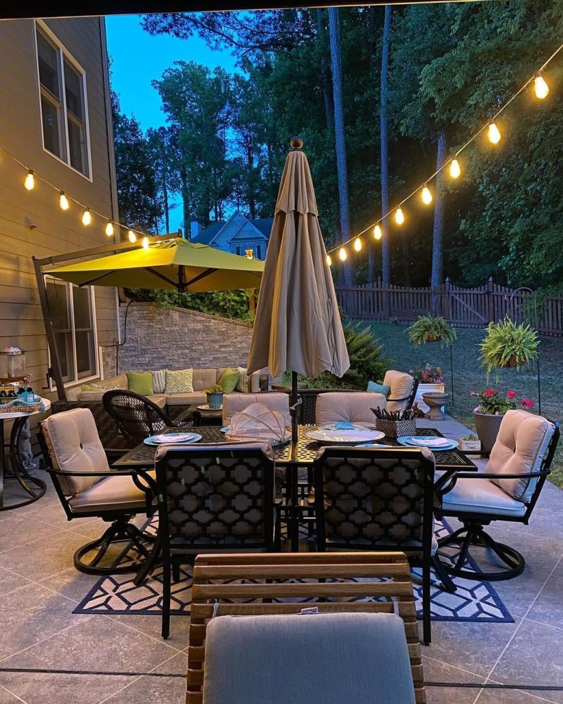 Evening patio with dining set string lights and lounge furniture