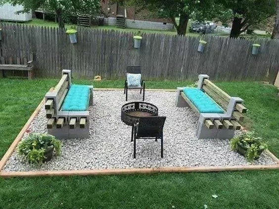 DIY backyard seating area with gravel base and cinder block benches