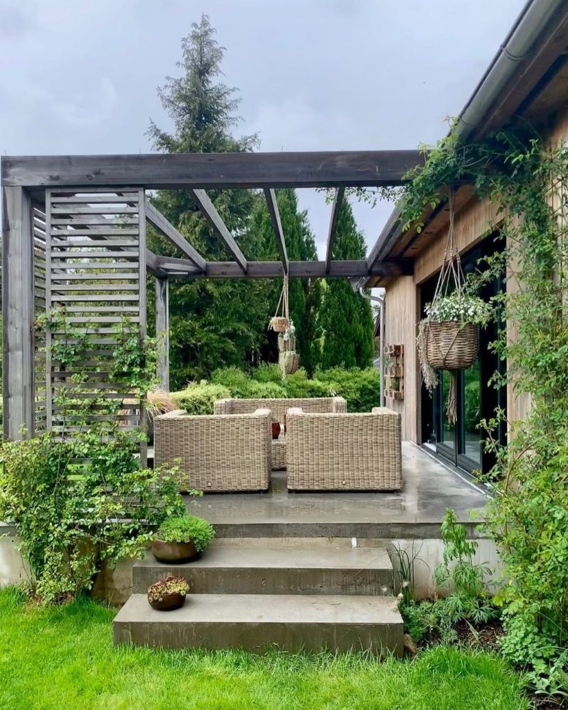 Modern pergola patio with wicker furniture and concrete steps