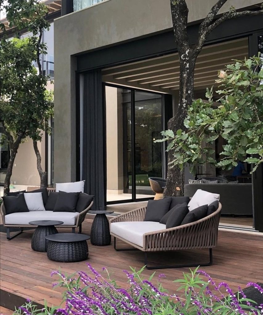 Modern patio furniture with purple flowers and sliding doors