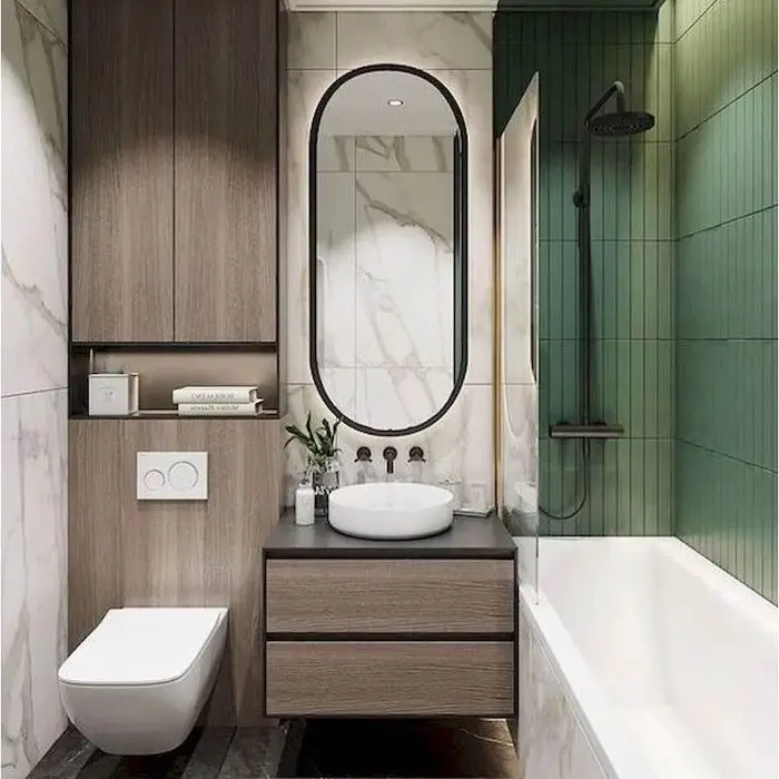 Modern bathroom with green accent wall oval mirror and floating vanity