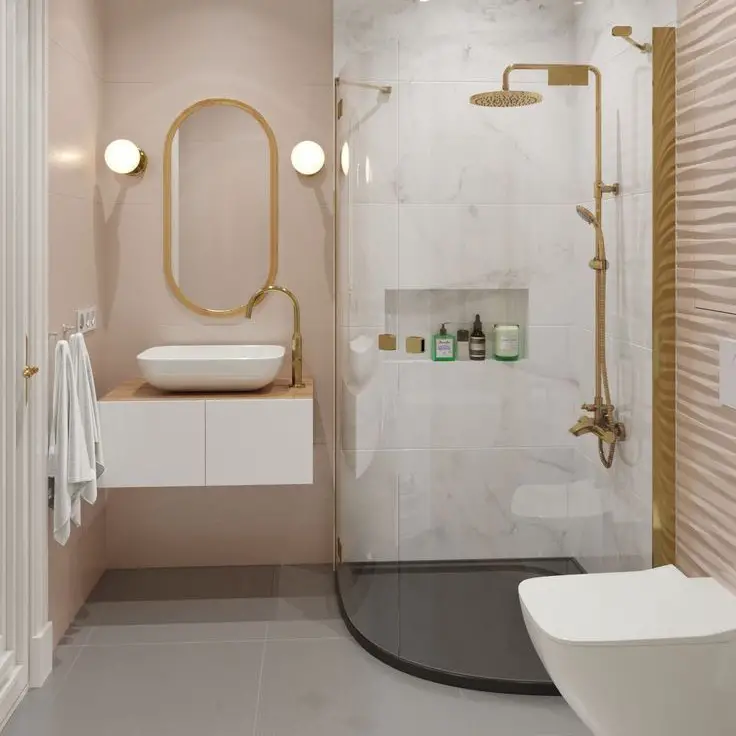 Pink and gold bathroom with oval mirror curved shower and marble walls
