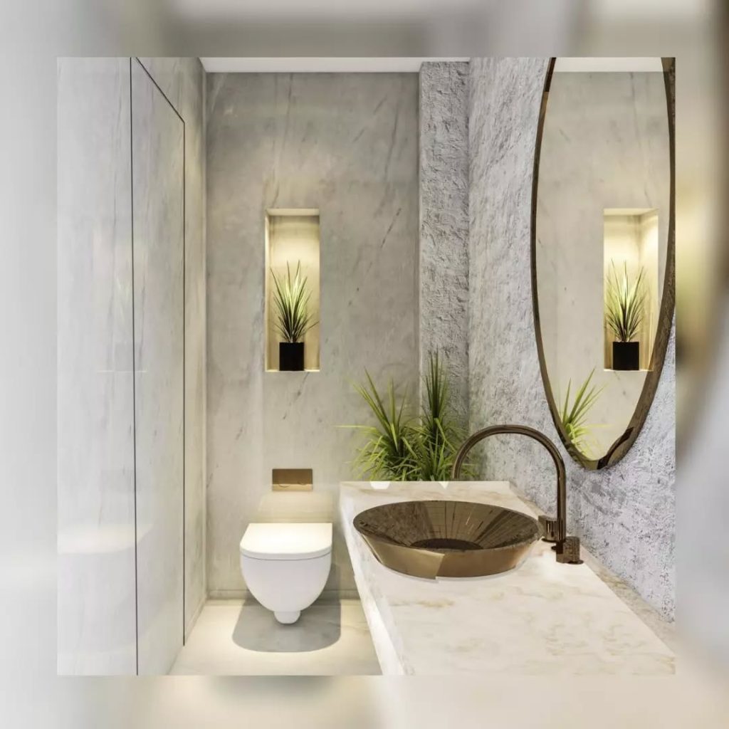 Luxury powder room with plant niches bronze sink and marble walls
