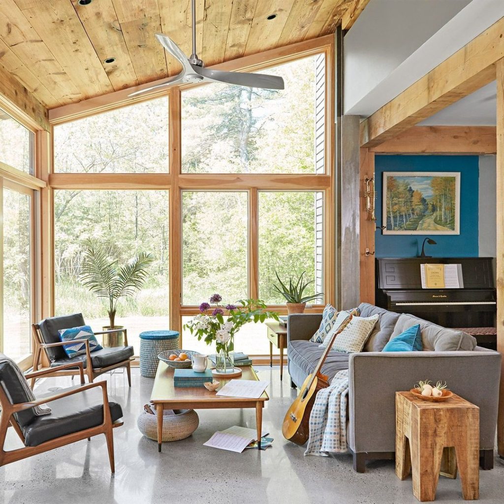 Modern sunroom with wooden beams piano and mid century furniture