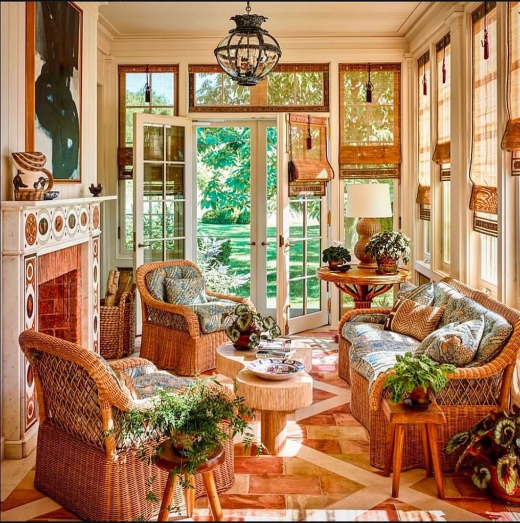 Elegant sunroom with wicker furniture ornate fireplace and bamboo shades