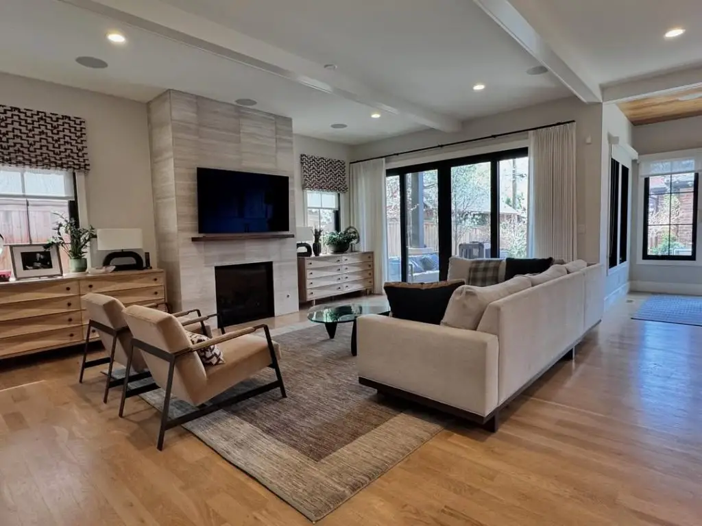 Minimalist sunroom with limestone fireplace neutral furniture and modern decor