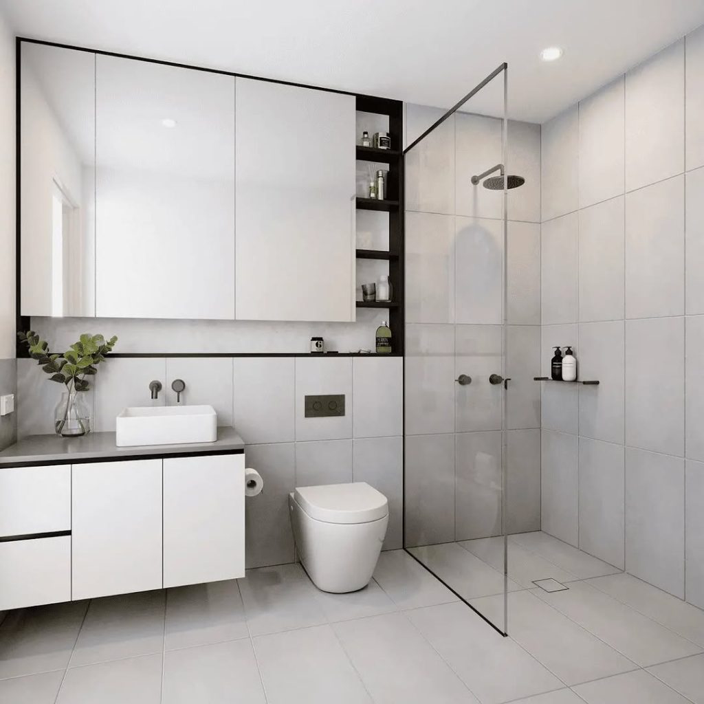 White minimalist bathroom with hidden storage black accents and frameless shower