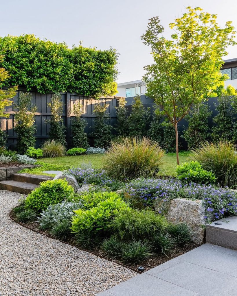 Layered modern garden with ornamental grasses and stone steps