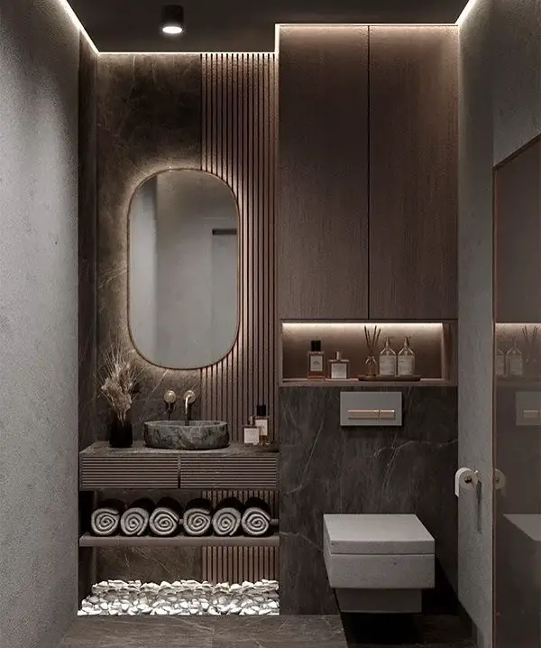 Dark modern powder room with backlit mirror marble walls and wooden accents