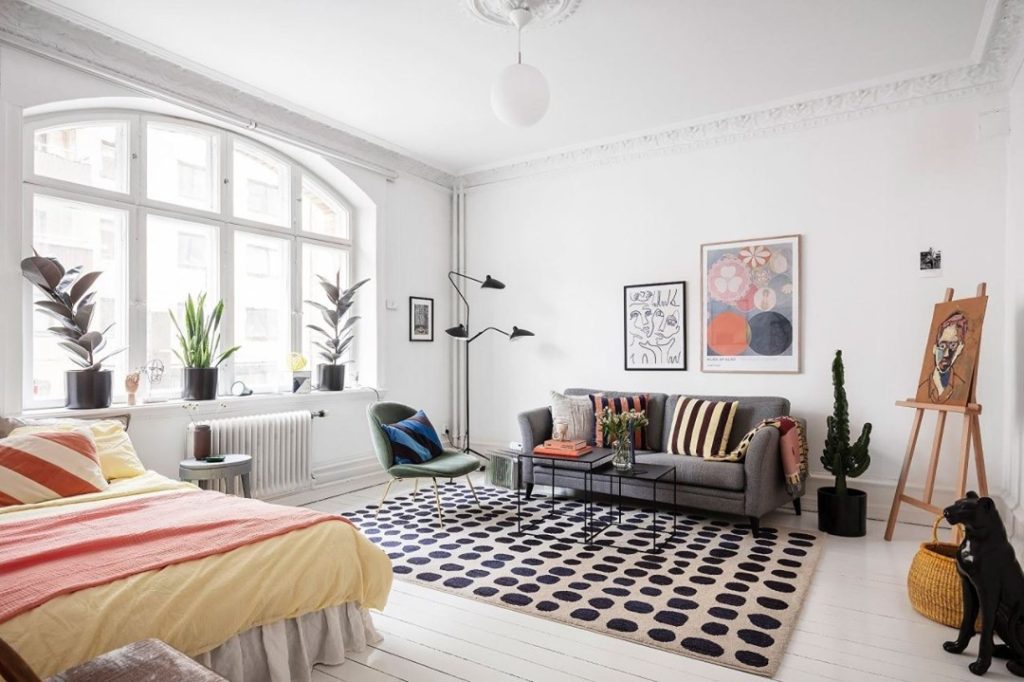 Bright studio apartment with easel artistic elements