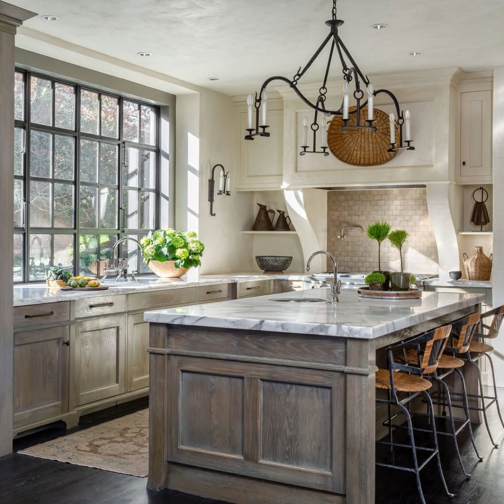 Farmhouse kitchen with wood island, marble counters, black windows