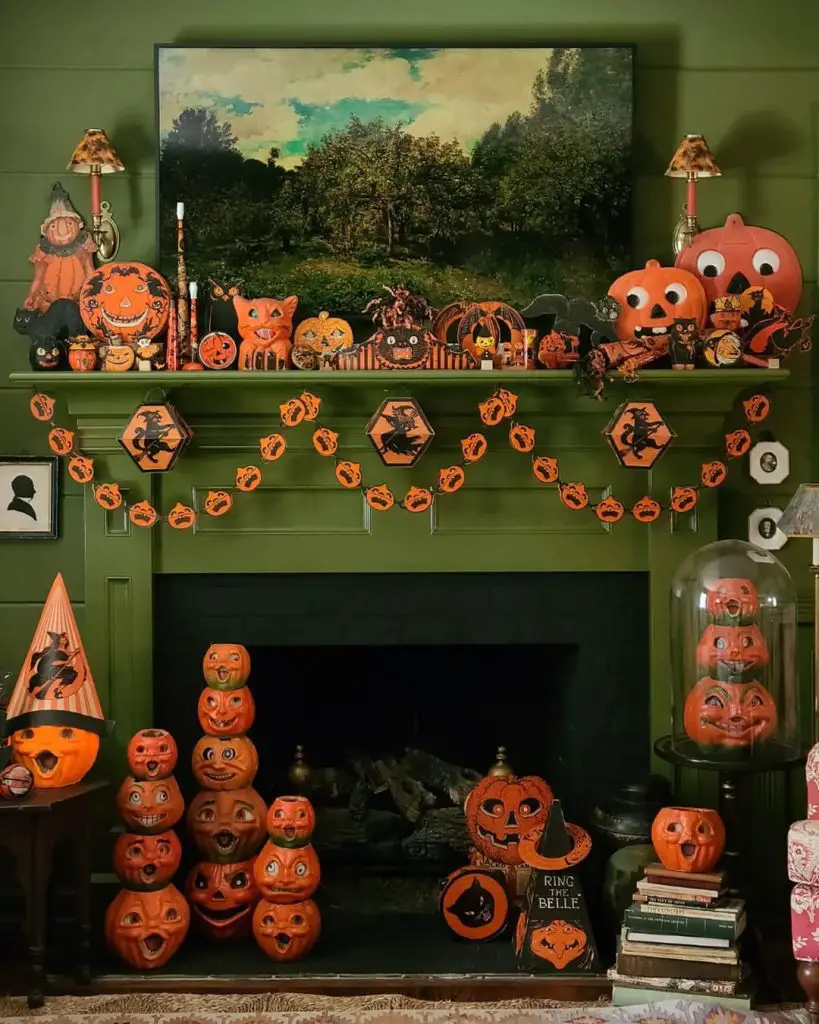 Vintage Halloween decorations displayed on green fireplace mantel with collectibles