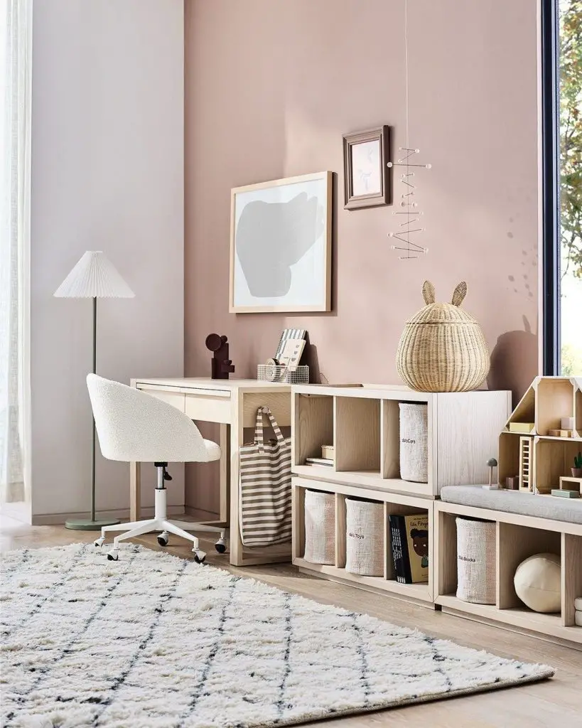 Pink-walled study corner with cube storage and rug