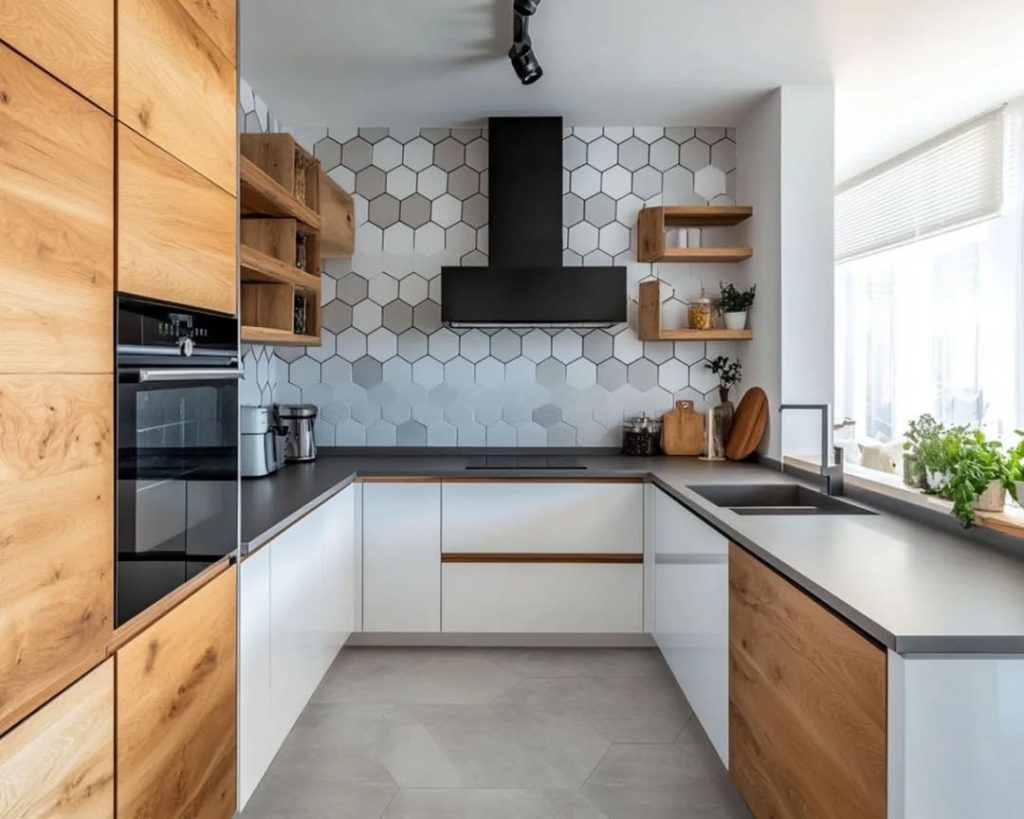 Two-tone kitchen with hexagonal tile wall, wood and white cabinets, dark countertops