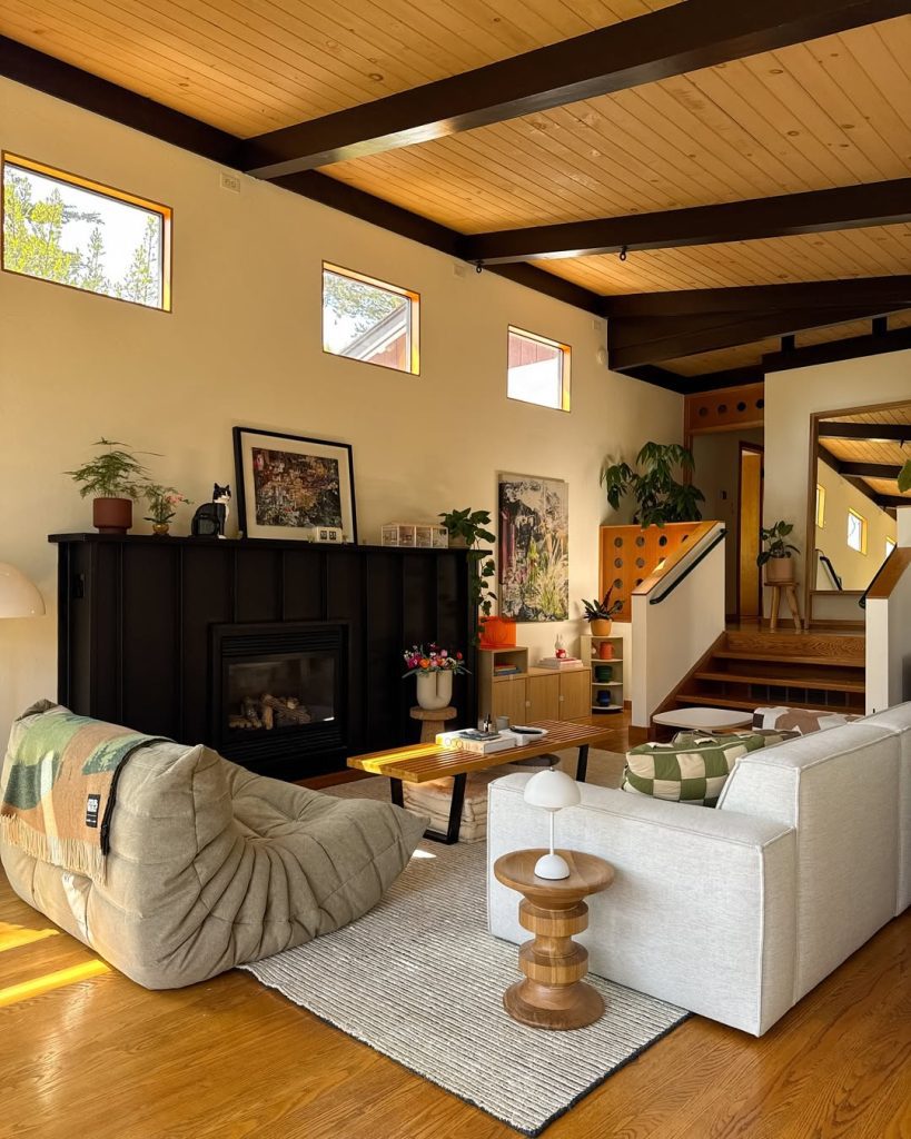 Living room with wood plank ceiling and black fireplace feature