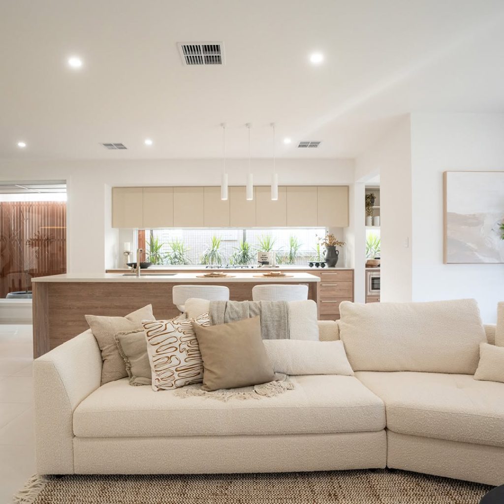 Neutral kitchen with wood grain cabinets and pendant lights