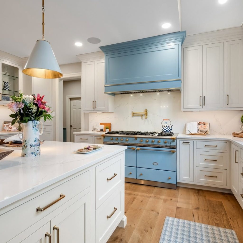  Kitchen with powder blue range, white cabinets, brass accents