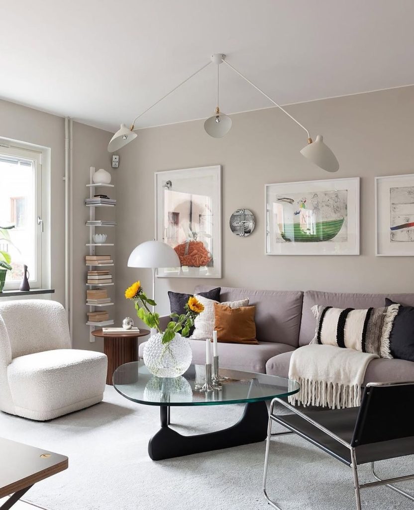 Gray sectional sofa with multi-light fixture and glass coffee table