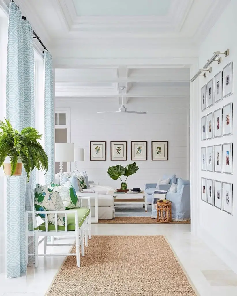 White living room with extensive gallery wall and coastal decor