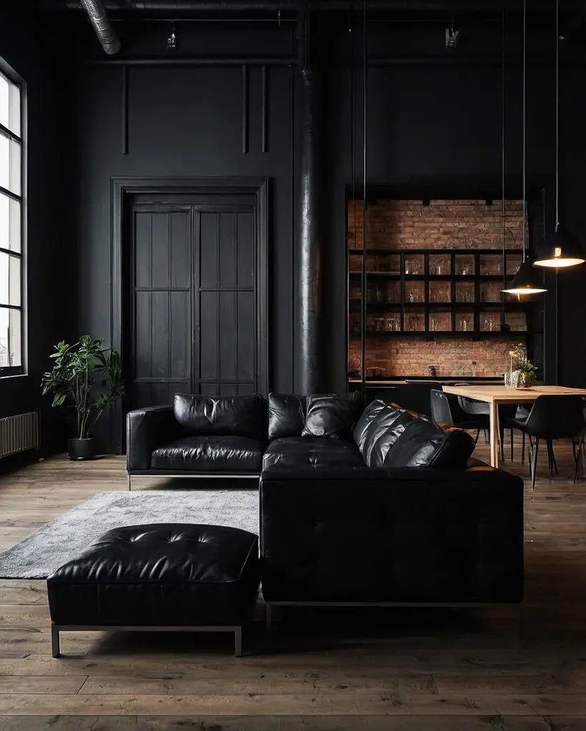 Industrial loft with black leather sofa and exposed brick kitchen