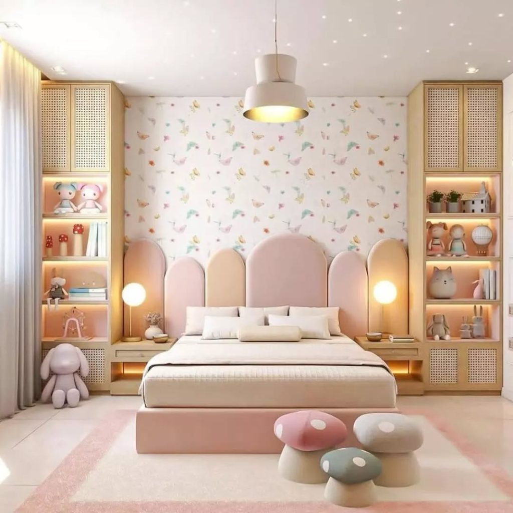 Pink kids bedroom with butterfly wallpaper and arched headboard