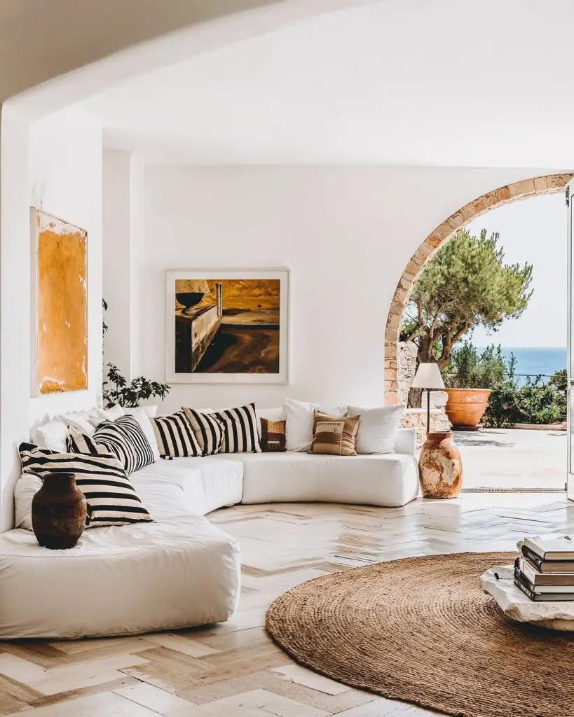 White coastal terrace with stone arch and ocean views