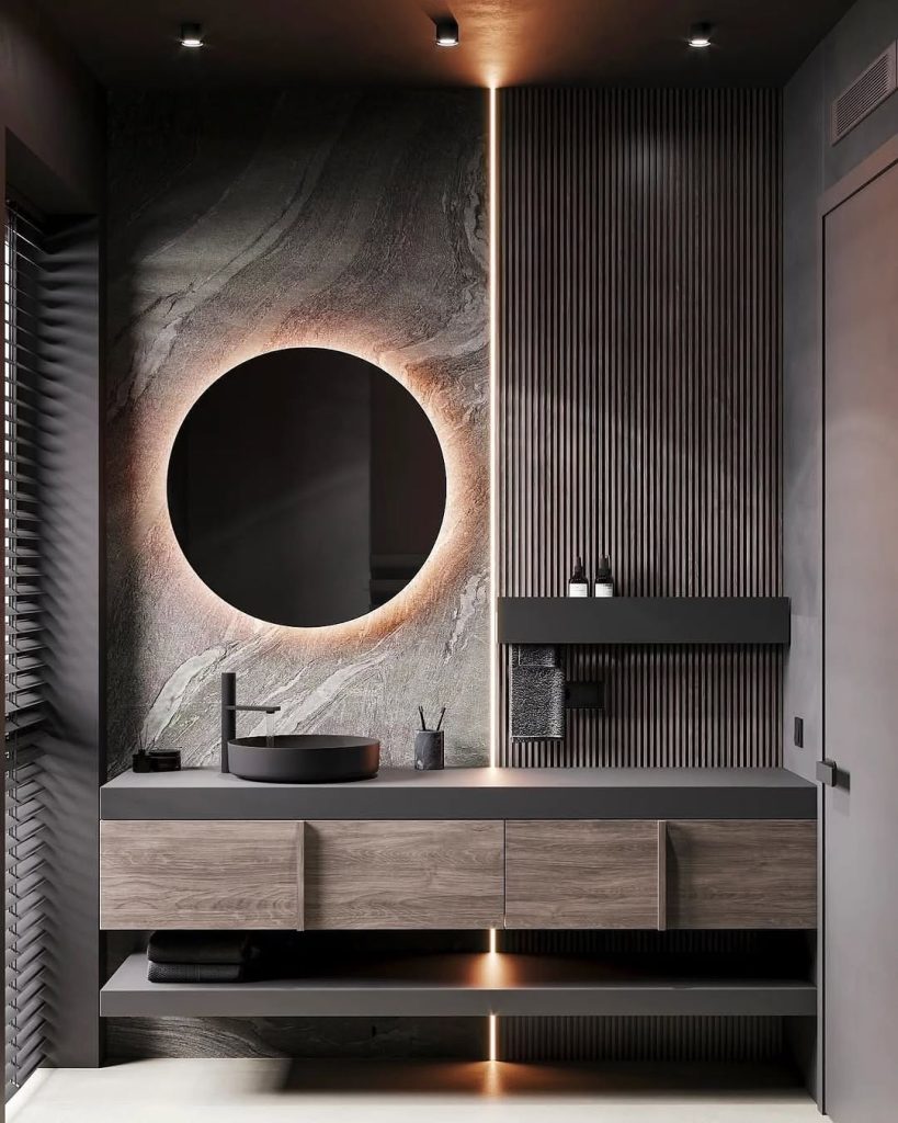 Modern bathroom with wood vanity and circular backlit mirror