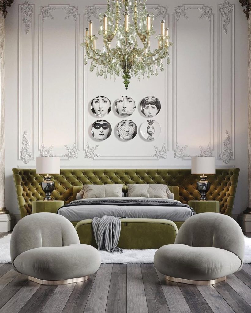 Elegant bedroom with portrait gallery and green tufted headboard