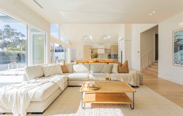 Open kitchen and living space with neutral tones and natural light