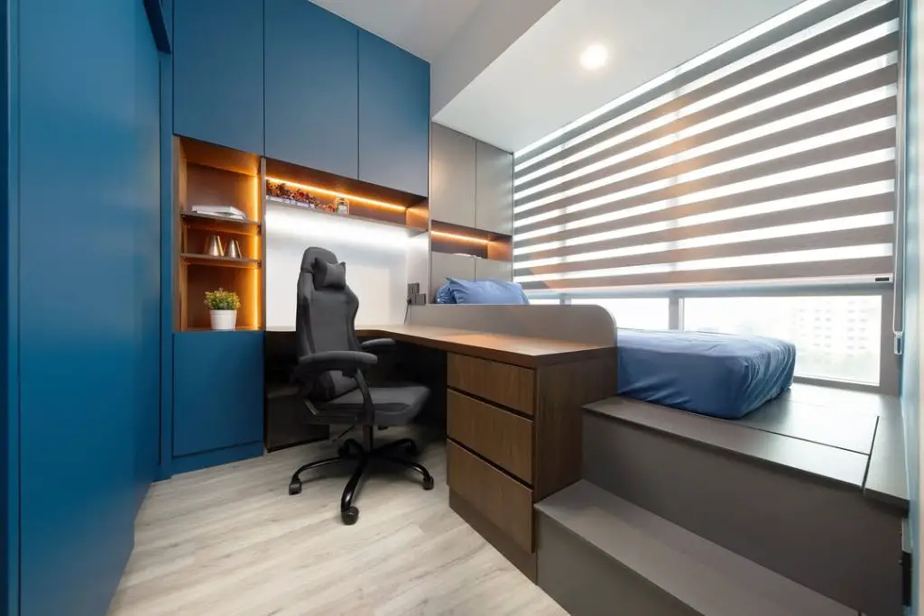 Teen bedroom with navy cabinets and L-shaped desk