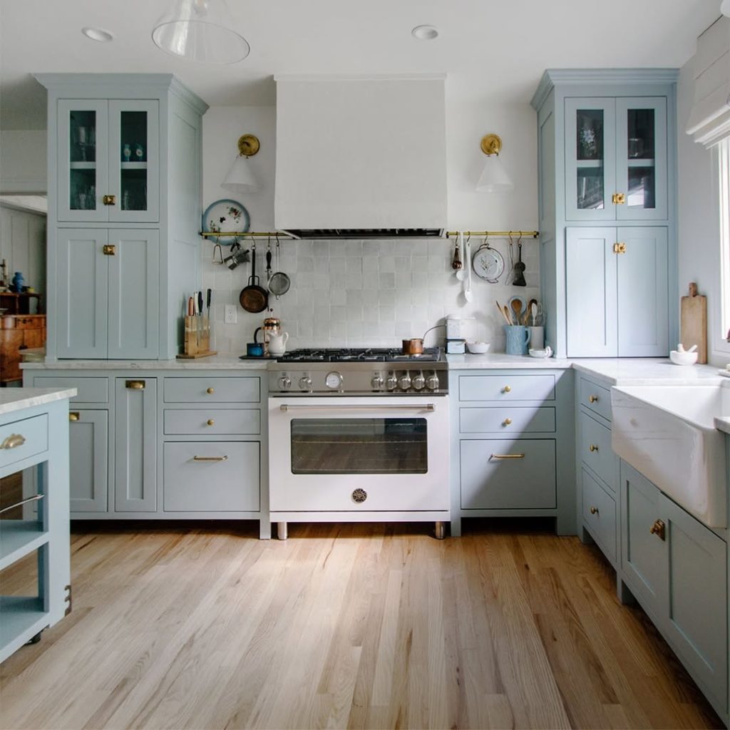Sage green kitchen with brass hardware farmhouse sink