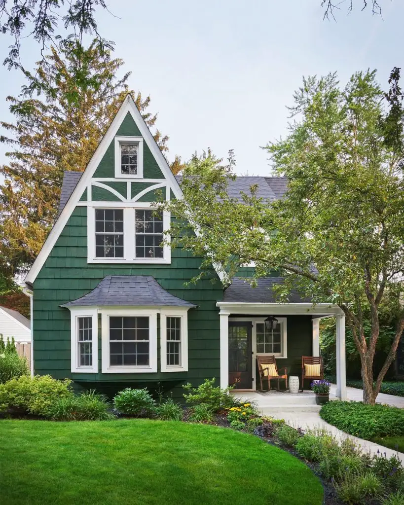 Green Tudor cottage with white timber details