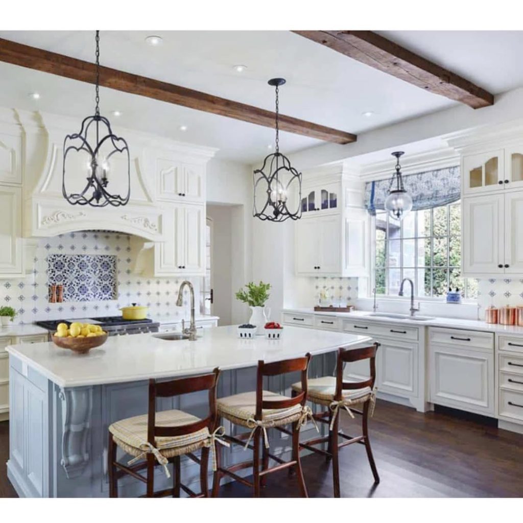 White kitchen with blue island decorative tile backsplash