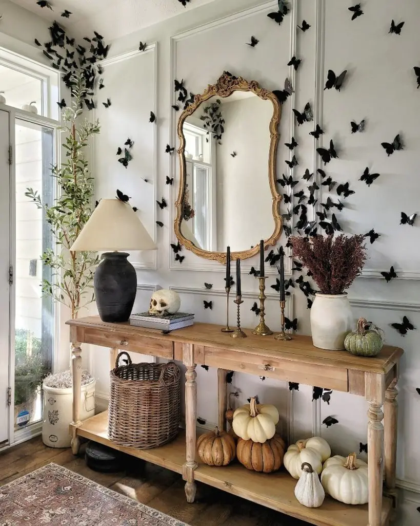 Entryway with black butterfly wall art and autumn pumpkins
