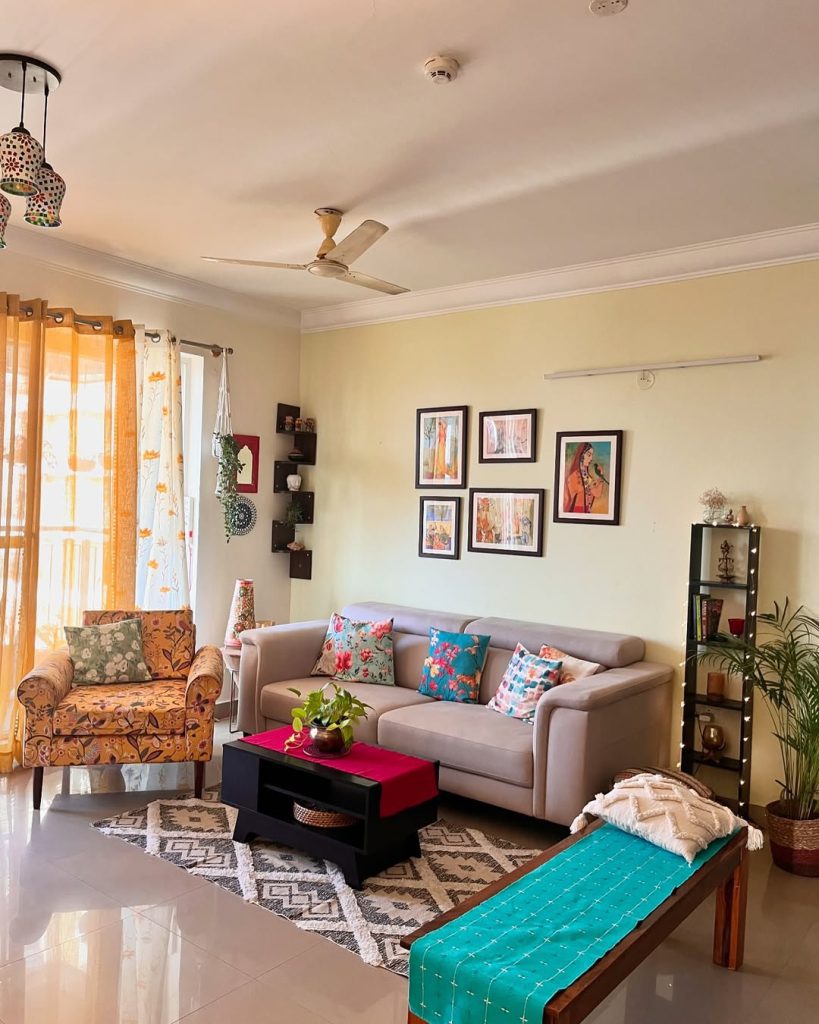 Gray sofa with colorful pillows and geometric patterned area rug