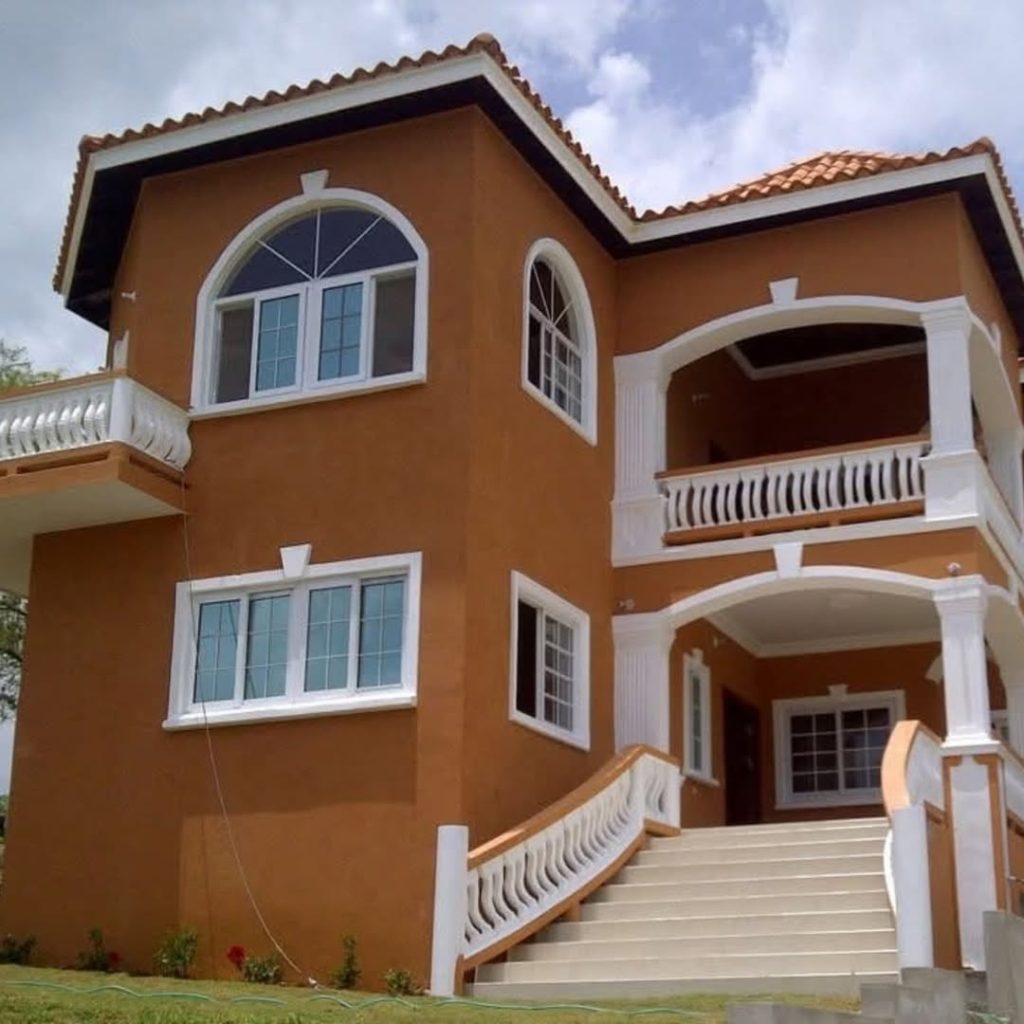 Golden stucco villa with curved staircase balconies
