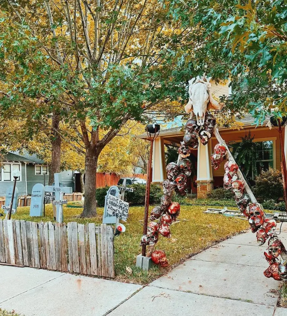 Front yard Halloween display featuring bloody skull garlands and tombstones