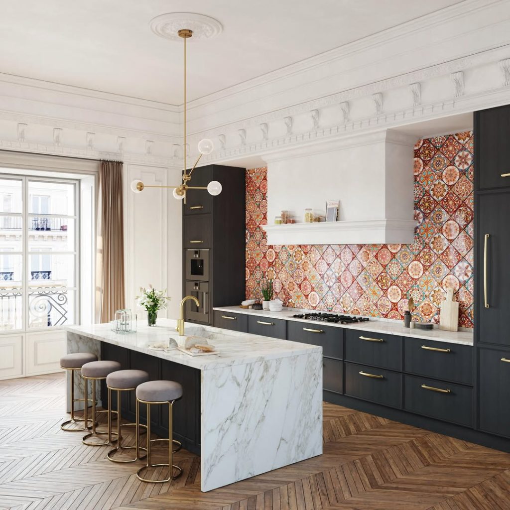 Kitchen with Moroccan tile backsplash, dark cabinets, marble waterfall island, brass hardware