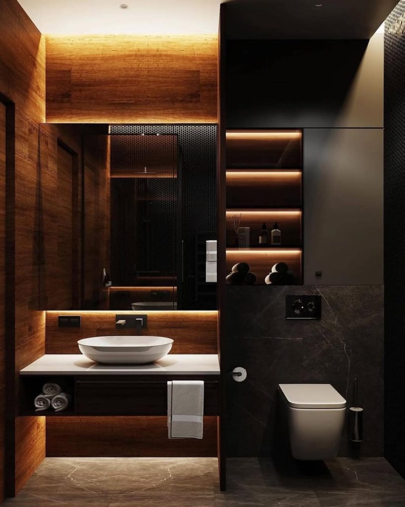 Modern spa bathroom with warm wood accents and illuminated shelving