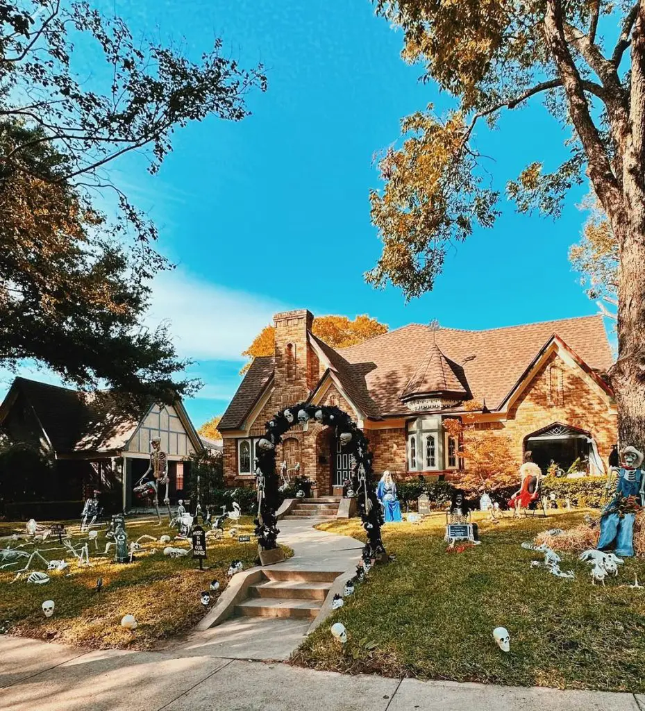 Elaborate Halloween graveyard scene with multiple skeletons and tombstone decorations
