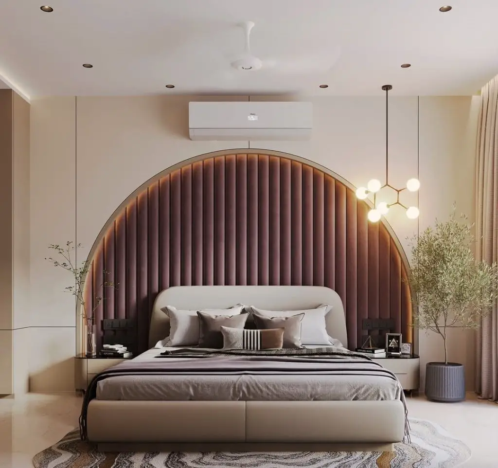 Bedroom with curved channeled headboard geometric pendant lights
