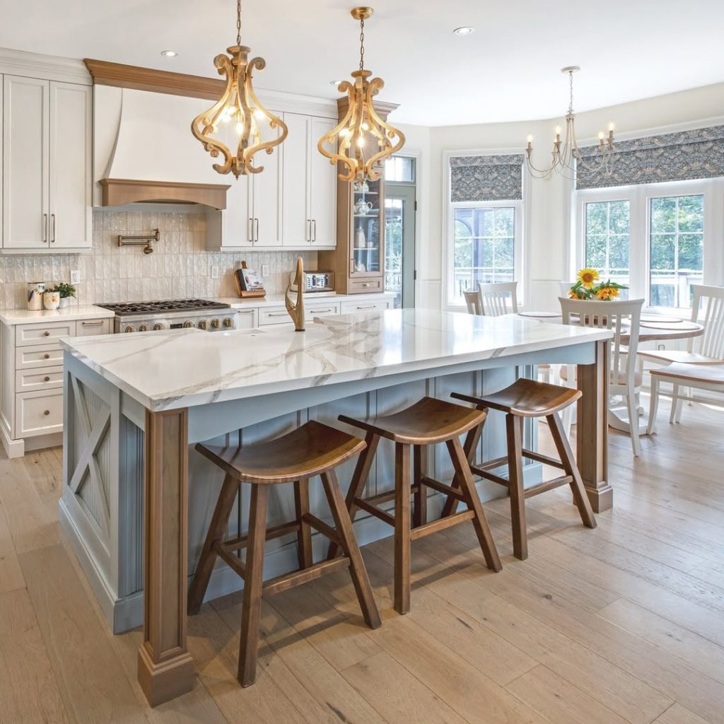 Traditional kitchen with golden chandeliers marble island breakfast nook